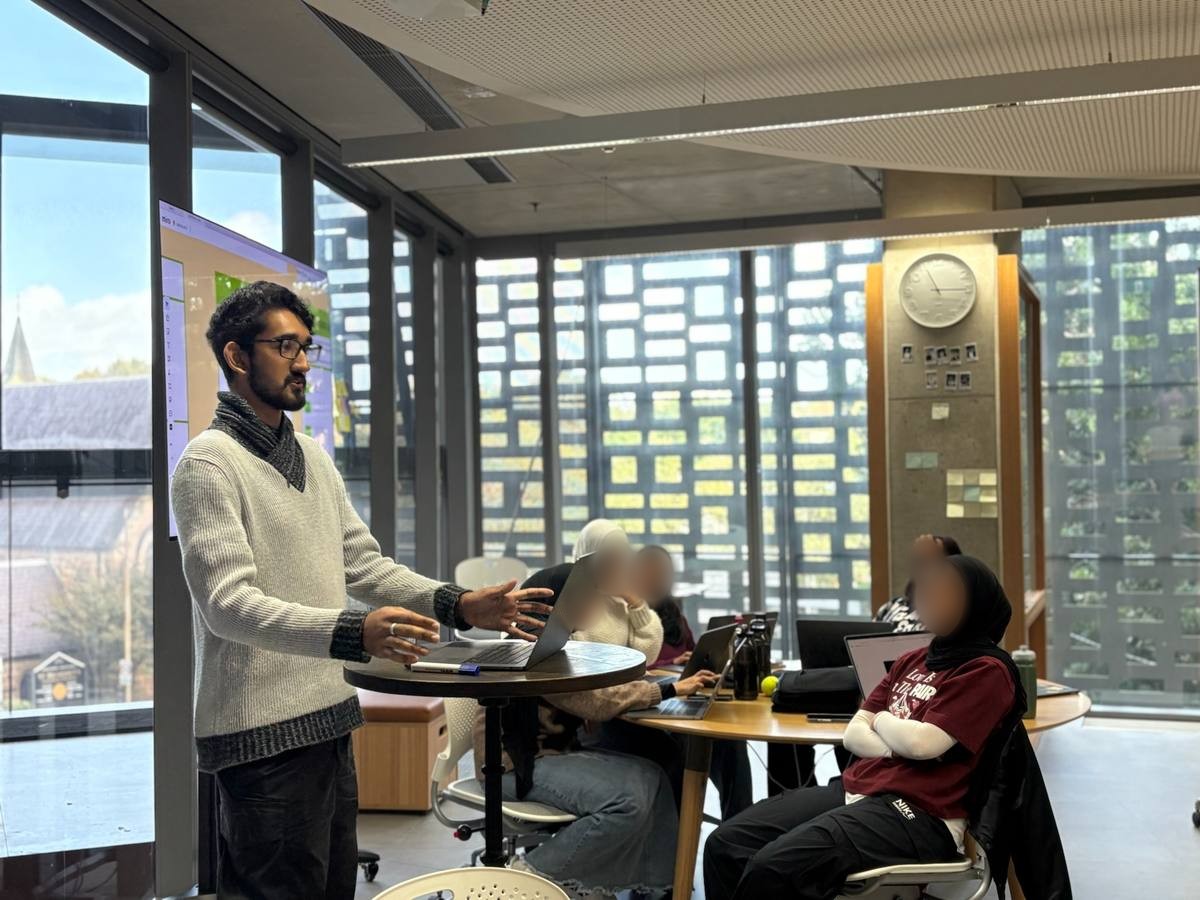 Noah facilitating a group discussion with a cohort.