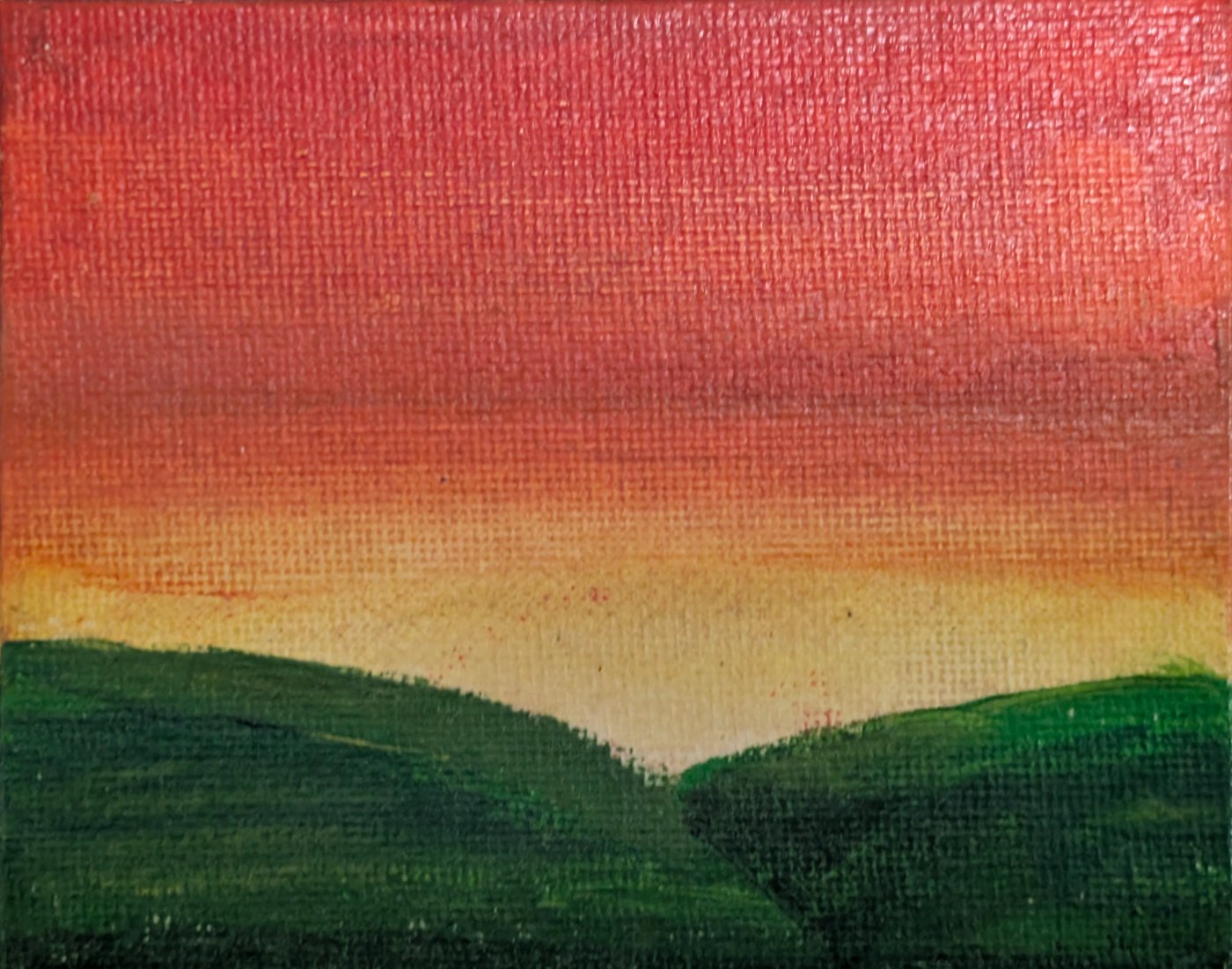 Small canvas painting of green hills under a sunset sky, yellow at the horizon rising to red